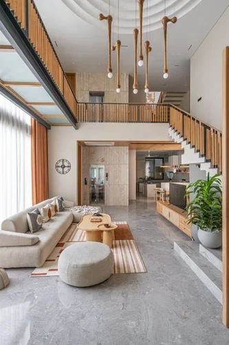 Double-height living room with sculptural pendant lights, wood slat panelling and a floating staircase